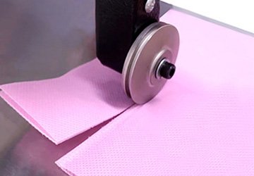 Ultrasonic cutting of nonwoven fabrics